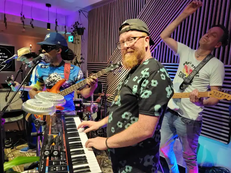Live band performing at Friday Night Live event with energetic musicians.