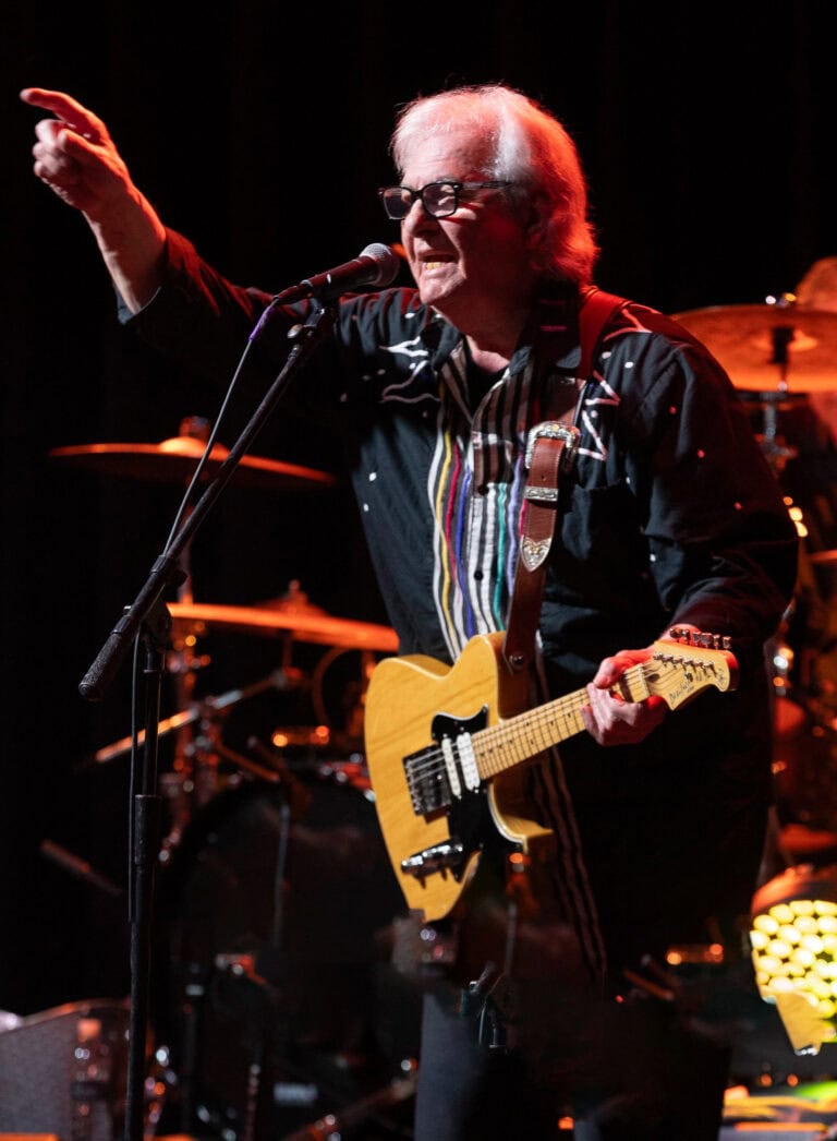 Legendary guitarist performing live at Friday Night Live event.